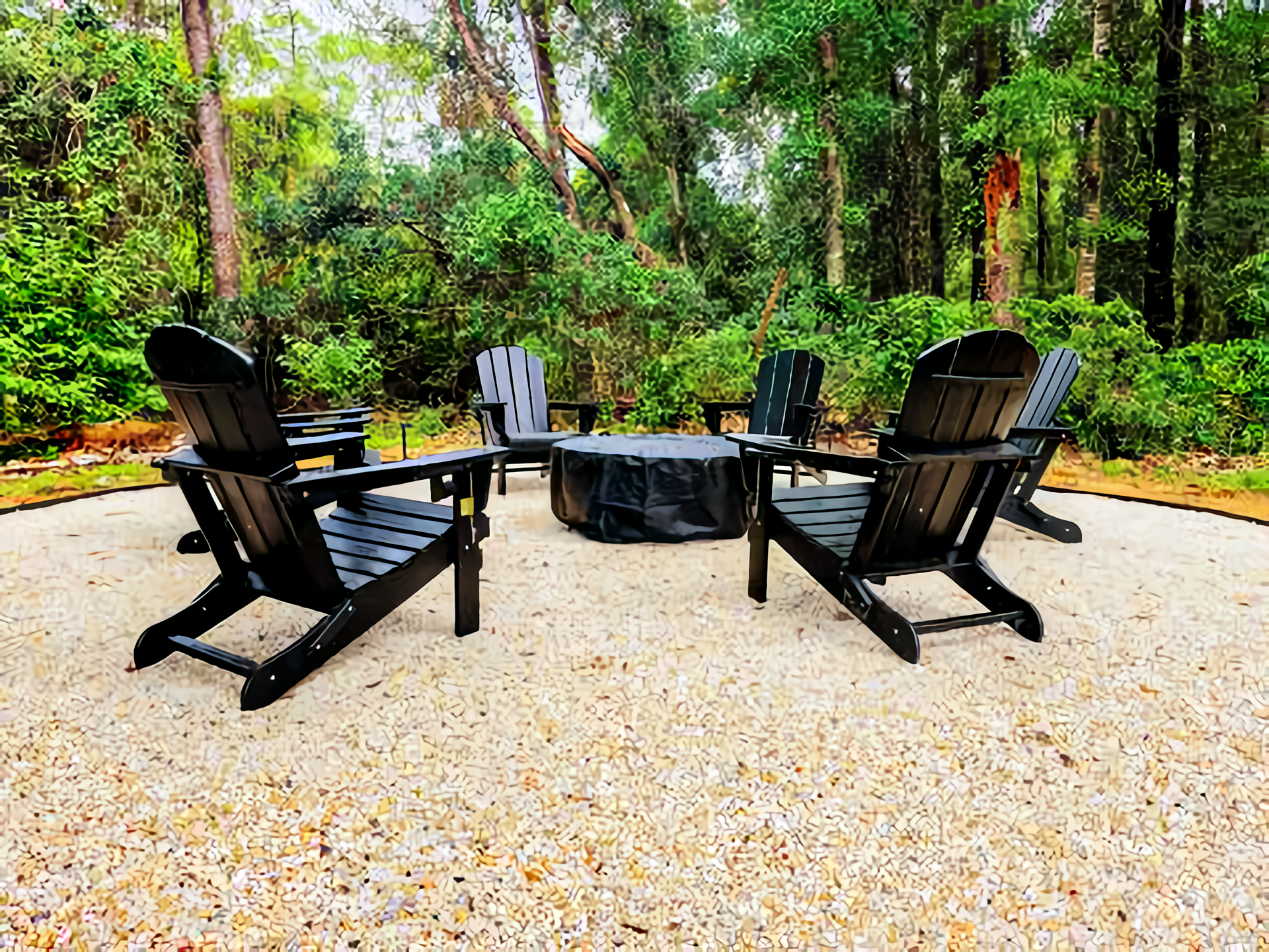Five black Adirondack chairs arranged in a circular pattern around a covered fire pit, set on a gravel area amidst lush green trees.